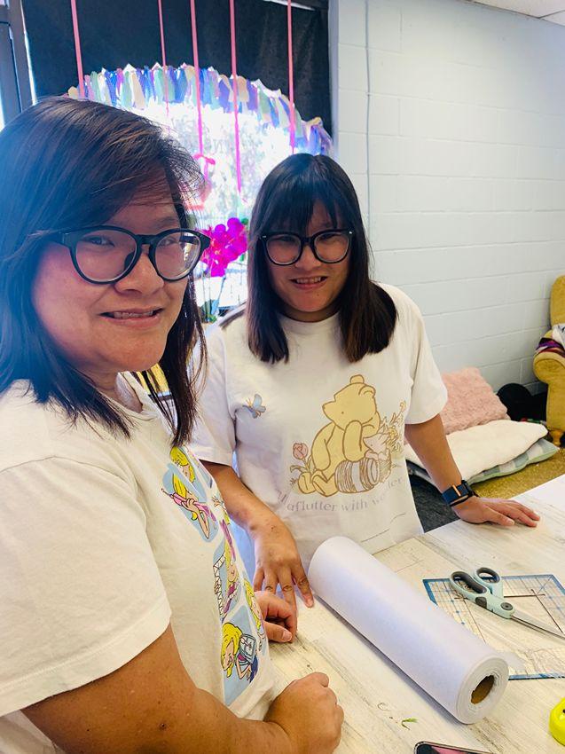 Friends creating together at a community craft table