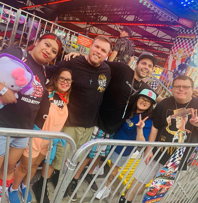 Friends from You're Invited Church together at a fair, smiling and celebrating