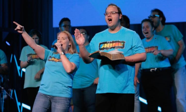 Worship team singing together on stage