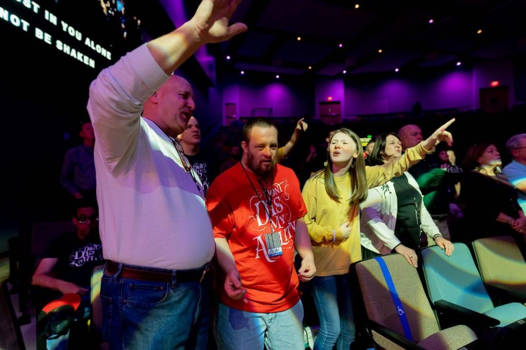 Friends worshiping together during the service